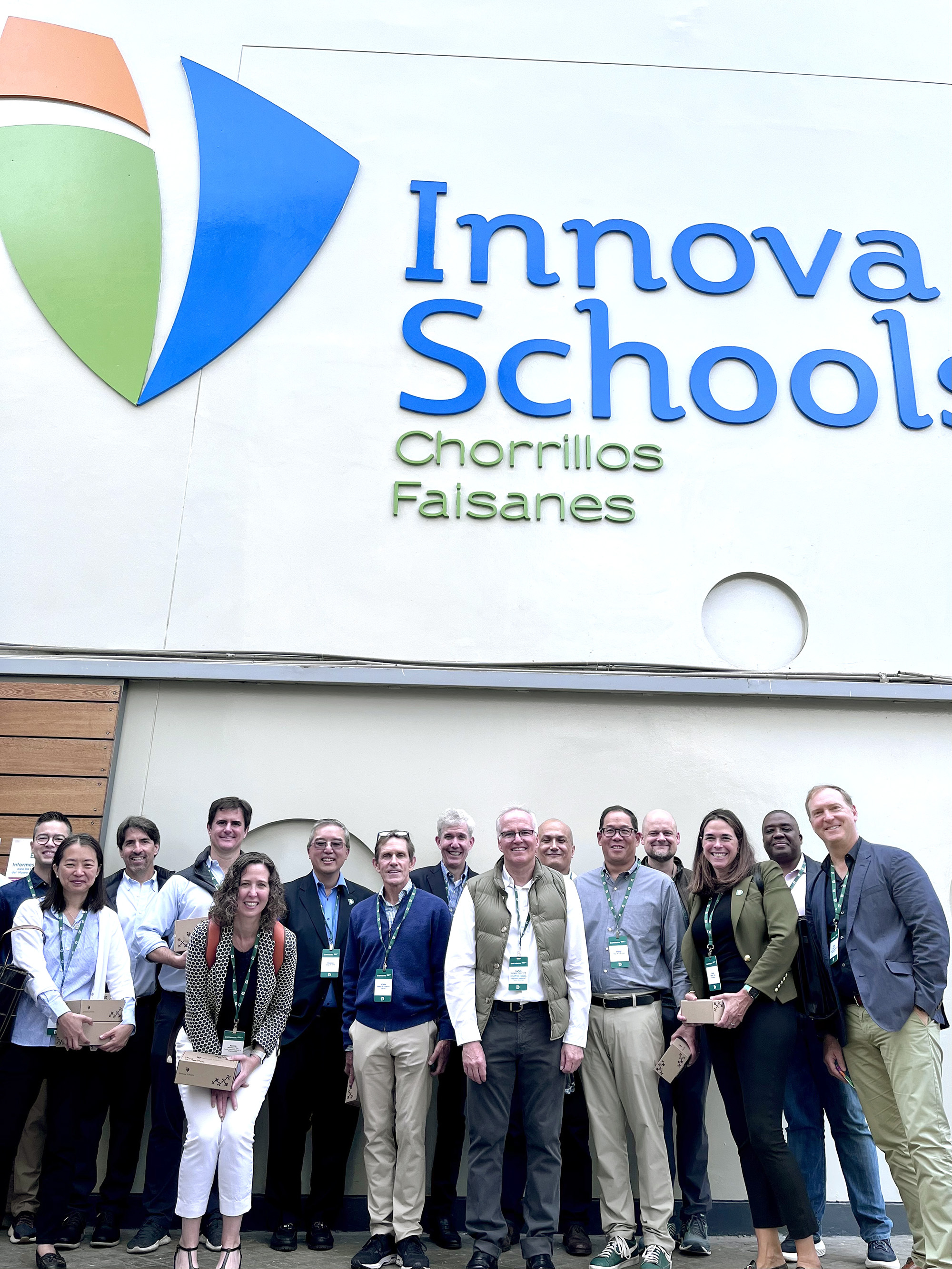 A Dartmouth group standing outside of Innova Schools with Trustee Emeritus Carlos Rodríguez-Pastor TU'88